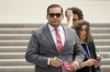 FILE - U.S. Rep. George Santos, R-N.Y., holds a miniature American flag that was presented to him as he departs federal court, June 30, 2023, in Central Islip, N.Y. Santos on Wednesday, Sept. 13, missed another deadline to submit a key financial disclosure report, a months-long delay that the embattled New York Republican blamed on his federal taxes and the desire to avoid a “rushed job.” (AP Photo/John Minchillo, File)
