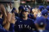 Texas Rangers' Evan Carter, center, is congratulated for his two-run home run against the Los Angeles Angels during the ninth inning of a baseball game Wednesday, Sept. 27, 2023, in Anaheim, Calif. (AP Photo/Jae C. Hong)