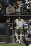 San Diego Padres' Jurickson Profar (10) celebrates with manager Bob Melvin left, at the dugout after scoring on a Ji Man Choi double during the first inning of a baseball game against the Chicago White Sox, Saturday, Sept. 30, 2023, in Chicago. (AP Photo/Paul Beaty)