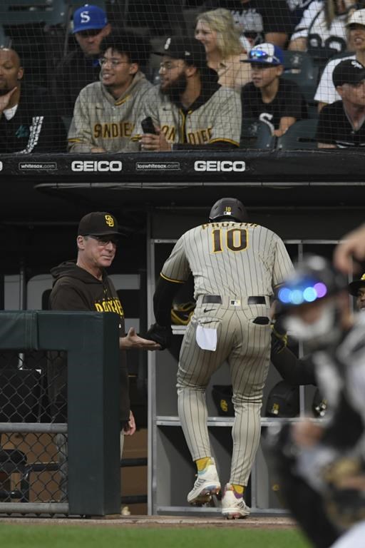 San Diego Padres' Jurickson Profar (10) celebrates with manager Bob Melvin left, at the dugout after scoring on a Ji Man Choi double during the first inning of a baseball game against the Chicago White Sox, Saturday, Sept. 30, 2023, in Chicago. (AP Photo/Paul Beaty)