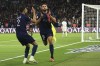 PSG's Achraf Hakimi, left, celebrates with PSG's Goncalo Ramos, center, who scored his side's third goal during the French League One soccer match between Paris Saint Germain and Olympique de Marseille at Parc des Princes stadium in Paris, France, Sunday, Sept. 24, 2023. (AP Photo/Aurelien Morissard)