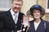 FILE - Manchester United manager Sir Alex Ferguson and wife Cathy after he was knighted by the Queen, in London, July 20 1999. Flags at Old Trafford have been lowered to half-staff following the death of the wife of former Manchester United manager Alex Ferguson. United says in a statement on Friday, Oct. 6, 2023 that Cathy Ferguson has died at the age of 84. (John Stillwell/PA via AP, file)