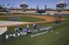 Los Angeles Dodgers grounds crew workers paint the post season logo on the field during practice ahead of the NLDS Friday, Oct. 6, 2023, in Los Angeles. (AP Photo/Mark J. Terrill)