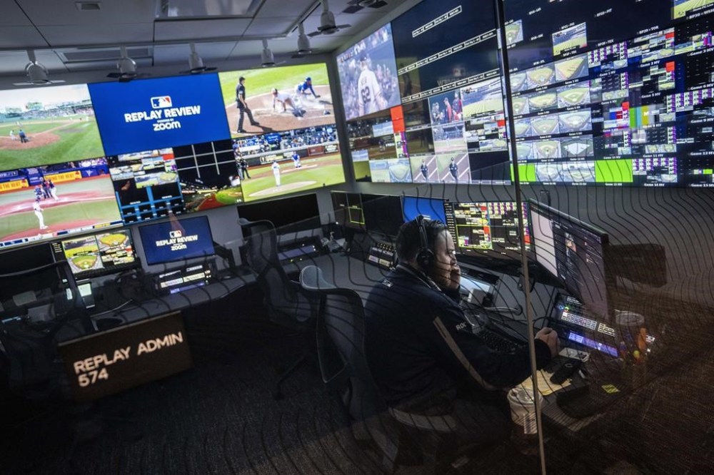 FILE - An employee works inside an administrative room at a Replay Review station during a tour at Major League Baseball headquarters in New York, March 28, 2023. Team-initiated video reviews were slightly less successful in the major leagues this year, dropping to 48.5% from 50.2% in 2022. (AP Photo/John Minchillo, File)