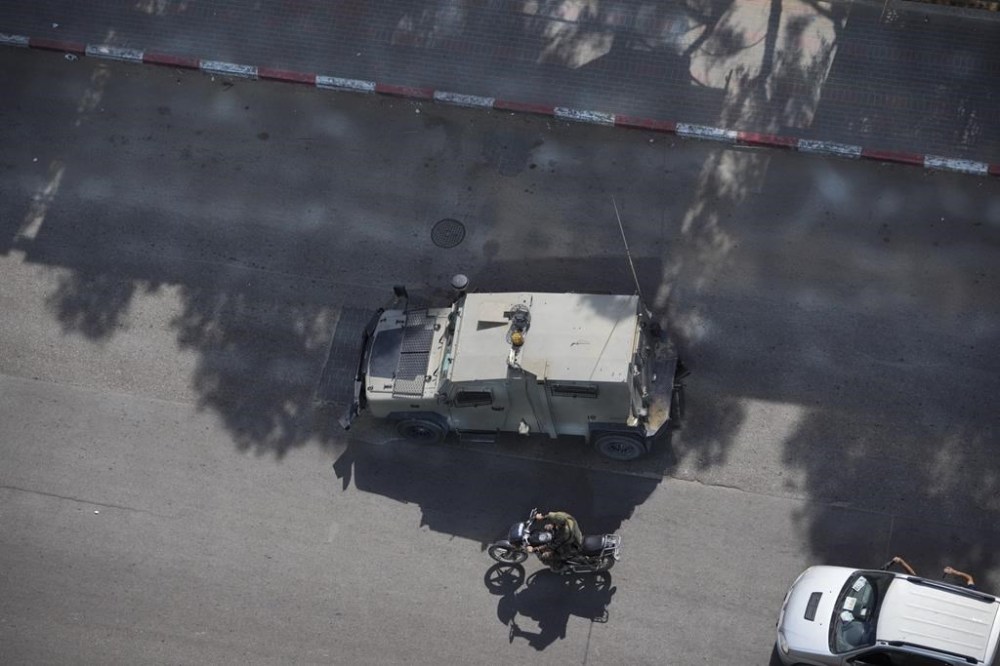 Palestinian militants drive a captured Israeli military vehicle in Gaza City on Saturday, Oct. 7, 2023. The militant Hamas rulers of the Gaza Strip carried out an unprecedented, multi-front attack on Israel at daybreak Saturday, firing thousands of rockets as dozens of Hamas fighters infiltrated the heavily fortified border in several locations by air, land, and sea and catching the country off-guard on a major holiday. (AP Photo/Hatem Moussa)