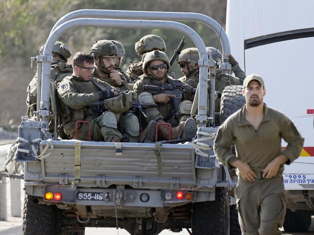 Israeli soldiers head south near Ashkelon, Israel, on Saturday, Oct. 7, 2023. Palestinian militants in the Gaza Strip infiltrated Saturday into southern Israel and fired thousands of rockets into the country while Israel began striking targets in Gaza in response. (AP Photo/Ohad Zwigenberg)