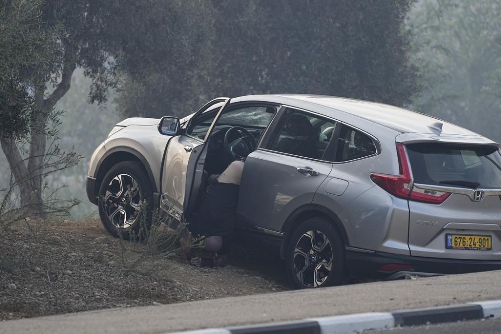 A man killed by Palestinian militants is seen in Sderot, Israel, on Saturday, Oct. 7, 2023. Palestinian militants in the Gaza Strip infiltrated Saturday into southern Israel and fired thousands of rockets into the country while Israel began striking targets in Gaza in response. (AP Photo/Ohad Zwigenberg)