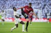 Real Madrid's Vinicius Junior, left, challenges for the ball with Osasuna's David Garcia during the Spanish La Liga soccer match between Real Madrid and Osasuna at the Santiago Bernabéu stadium in Madrid, Spain, Saturday, Oct. 7, 2023. (AP Photo/Jose Breton)