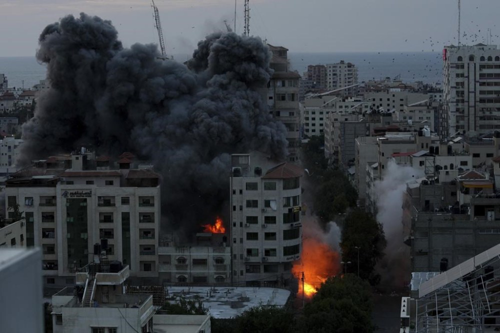 Fire and smoke rise from an explosion on a Palestinian apartment tower following an Israeli air strike in Gaza City, Saturday, Oct. 7, 2023. The militant Hamas rulers of the Gaza Strip carried out an unprecedented, multi-front attack on Israel at daybreak Saturday, firing thousands of rockets as dozens of Hamas fighters infiltrated the heavily fortified border in several locations by air, land, and sea and catching the country off-guard on a major holiday. (AP Photo/Adel Hana)
