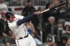 Atlanta Braves third baseman Austin Riley (27) hits a single against the Philadelphia Phillies during the eighth inning of Game 1 of a baseball NL Division Series, Saturday, Oct. 7, 2023, in Atlanta. (AP Photo/Brynn Anderson)