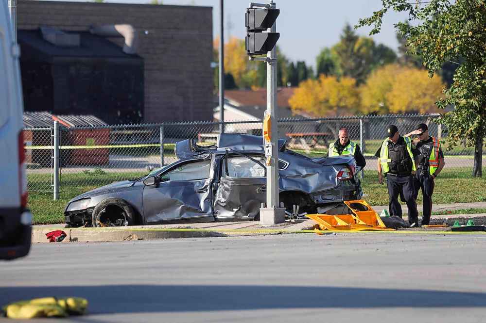 Police continue to investigate on Monday morning at the scene of a serious, single-vehicle collision that occurred Sunday evening at the corner of King Edward and Inkster Boulevard. (Ruth Bonneville / Winnipeg Free Press)