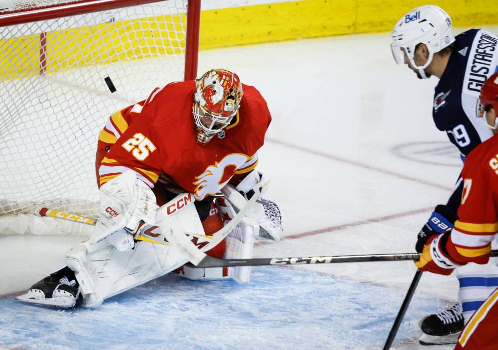 <p>JEFF MCINTOSH / THE CANADIAN PRESS</p>
                                <p>David Gustafsson (right) scores on goalie Jacob Markstrom during the second period of preseason hockey in Calgary.</p>