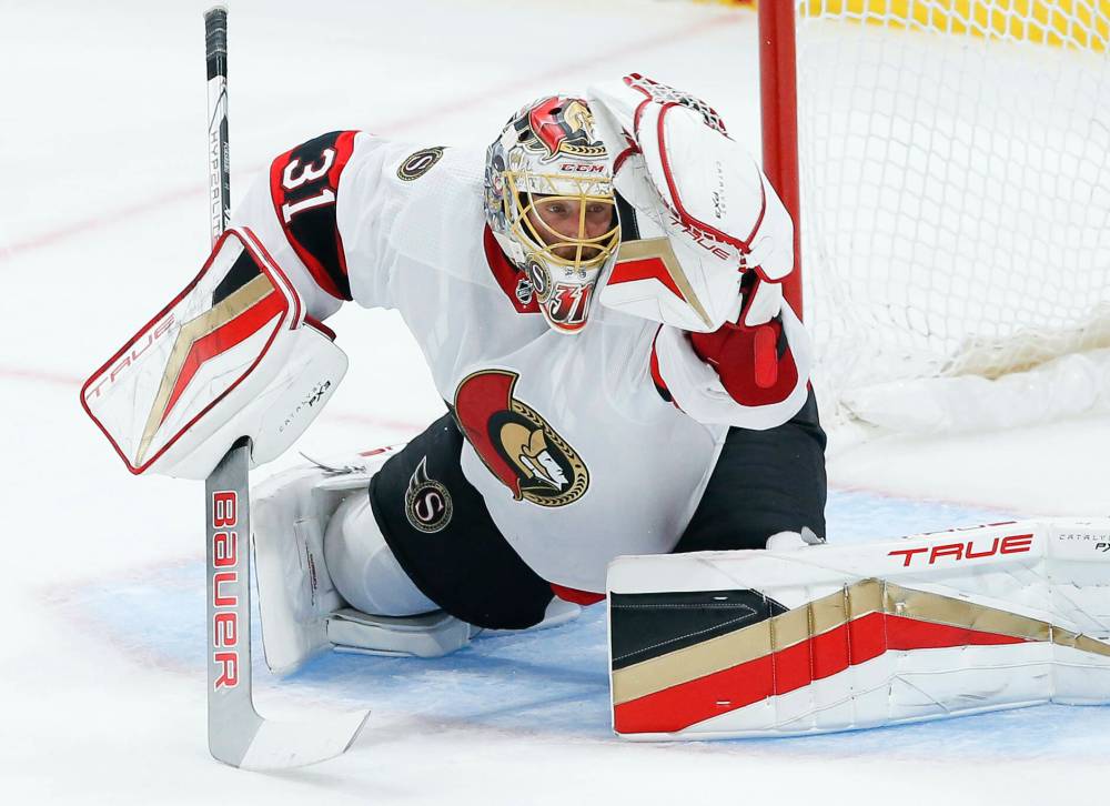Senators goaltender Anton Forsberg snags a shot from Mason Appleton Thursday in Winnipeg. (John Woods / The Canadian Press)
