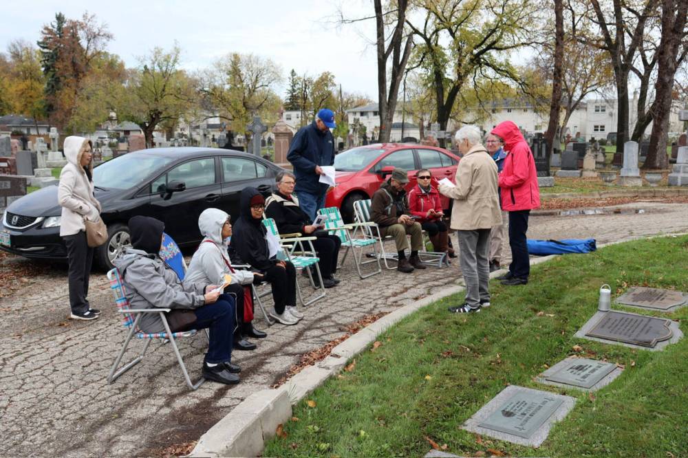 SUPPLIED
Veronica Dunne leads the Oct. 4 gathering in front of Cardinal Flahiff’s grave in St. Mary’s Cemetery.