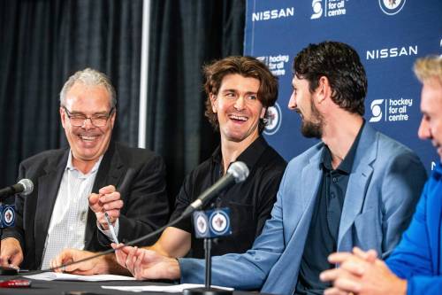 MIKAELA MACKENZIE / WINNIPEG FREE PRESS
                                Jets forward Mark Scheifele (centre) and goaltender Connor Hellebuyck (right) sign seven-year contract extensions with general manger Kevin Cheveldayoff at the Hockey For All centre on Tuesday.