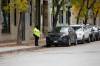 BROOK JONES / WINNIPEG FREE PRESS 
                                A parking compliance offer with the Winnipeg Parking Authority stands next to parked vehicle along Market Ave., in Winnipeg, Man., Oct. 5, 2023.