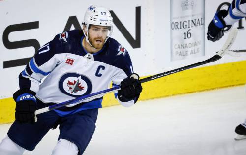 THE CANADIAN PRESS/Jeff McIntosh
                                Winnipeg Jets forward Adam Lowry skates during first period NHL hockey action against the Calgary Flames in Calgary, Wednesday.
