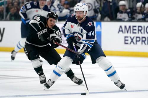 (AP Photo/Mark J. Terrill)
                                Winnipeg Jets defenceman Josh Morrissey, right, moves the puck as Los Angeles Kings center Blake Lizotte reaches for it during the first period of an NHL hockey game Thursday, Oct. 27, 2022, in Los Angeles.