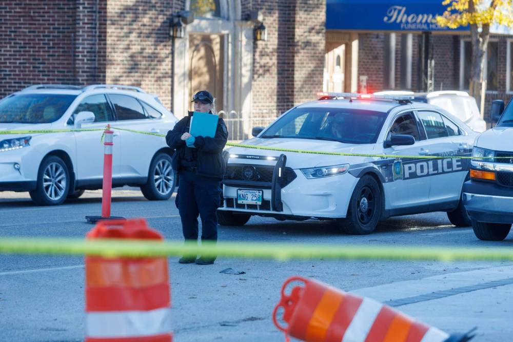 A WPS forensics unit investigates at Broadway and Sherbrook Avenue Monday morning. Traffic was blocked going east on Broadway and down to one lane westbound. (Mike Deal / Winnipeg Free Press)