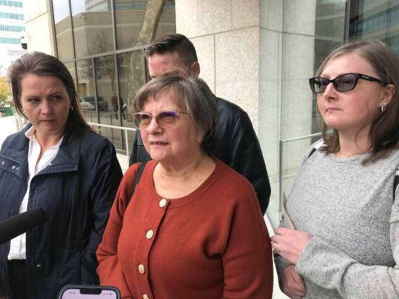 Candyce Szkwarek (centre) speaks to reporters outside court Tuesday after a judge declared her attacker Trevor Farley not criminally responsible for his actions. (Dean Pritchard / Winnipeg Free Press)