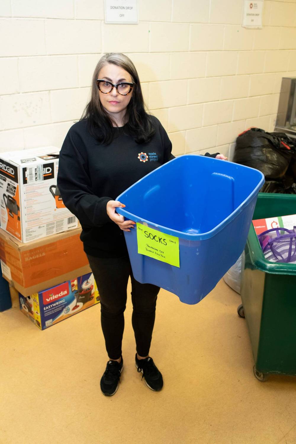 BROOK JONES / WINNIPEG FREE PRESS
Main Street Project communications specialist Cindy Titus holds an empty bin for socks. The agency hopes to collect at least 30,000 new pairs.