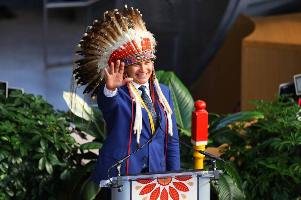 Manitoba NDP Leader Wab Kinew wore a traditional war bonnet during the ceremony. It was given to him by Sioux Valley Dakota Nation Chief Jennifer Bone and Canupawakpa Dakota Chief Lola Thunderchild. (Mike Deal / Winnipeg Free Press)