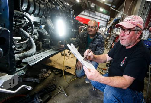 JOHN WOODS / WINNIPEG FREE PRESS FILES
                                Johnny Vernaus, president of Vernaus Auto Body, with technician Roy Samlal, says minor claims are processing quickly, but vehicles with extensive damage are taking longer to be assessed.