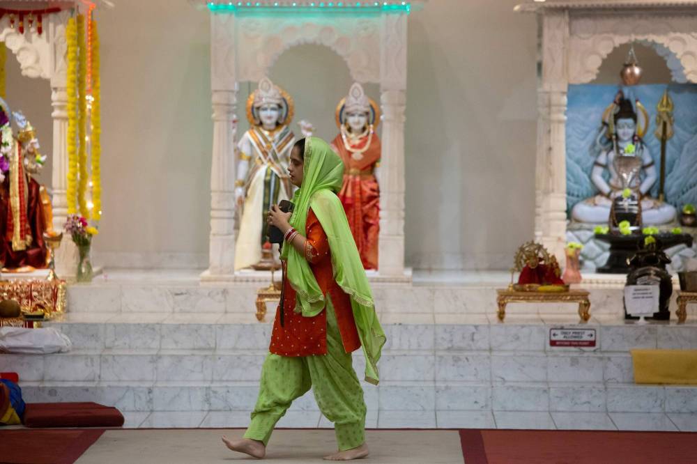 BROOK JONES / WINNIPEG FREE PRESS
                                A member of the Hindu Soceity of Manitoba walks in front of the altar during the festival.