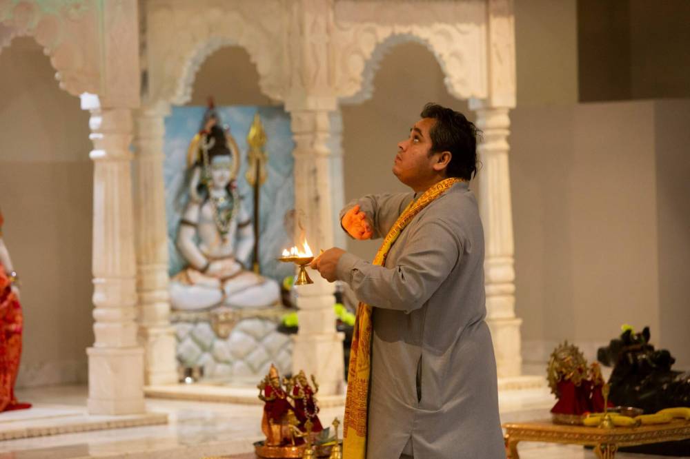 BROOK JONES / WINNIPEG FREE PRESS
                                Pandit Vimlesh Jha, who is a priest with the Hindu Society of Manitoba, performing Aarti, which is the final offering to the Hindu Goddess of Durga. The fourth day of the festival the Goddess of Durga is known as Kushmanda.