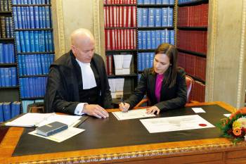 MIKE DEAL / WINNIPEG FREE PRESS
                                Cindy Lamoureux, interim Manitoba Liberal leader, takes her oath of office in the Manitoba Legislative library with Rick Yarish deputy clerk of the Manitoba Legislative Assembly, Friday.