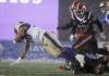 THE CANADIAN PRESS/Jeff McIntosh
                                Winnipeg Blue Bombers running back Brady Oliveira, left, dives for yards as Calgary Stampeders linebacker Micah Awe looks on during first half CFL football action in Calgary, Friday.