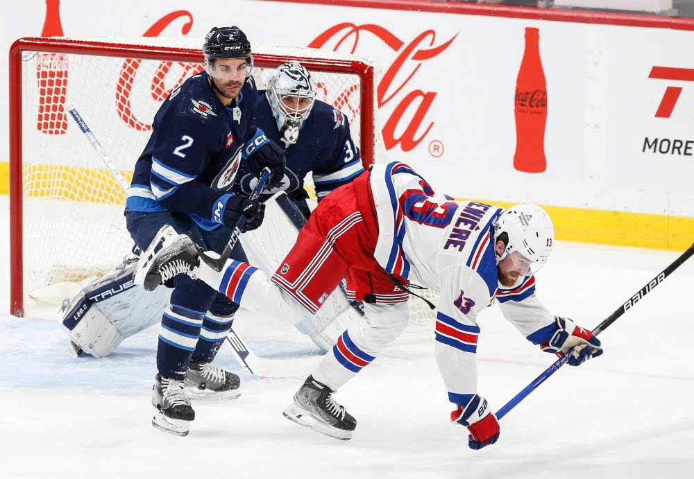 JOHN WOODS / WINNIPEG FREE PRESS
Winnipeg Jets’ Dylan DeMelo (2) defends against New York Rangers’ Alexis Lafrenière (13) in front of goaltender Connor Hellebuyck (37) during the first period.