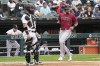 Arizona Diamondbacks' Jace Peterson, right, scores on a two-run double by Corbin Carroll as Chicago White Sox catcher Carlos Perez looks to the field during the third inning of a baseball game in Chicago, Wednesday, Sept. 27, 2023. (AP Photo/Nam Y. Huh)