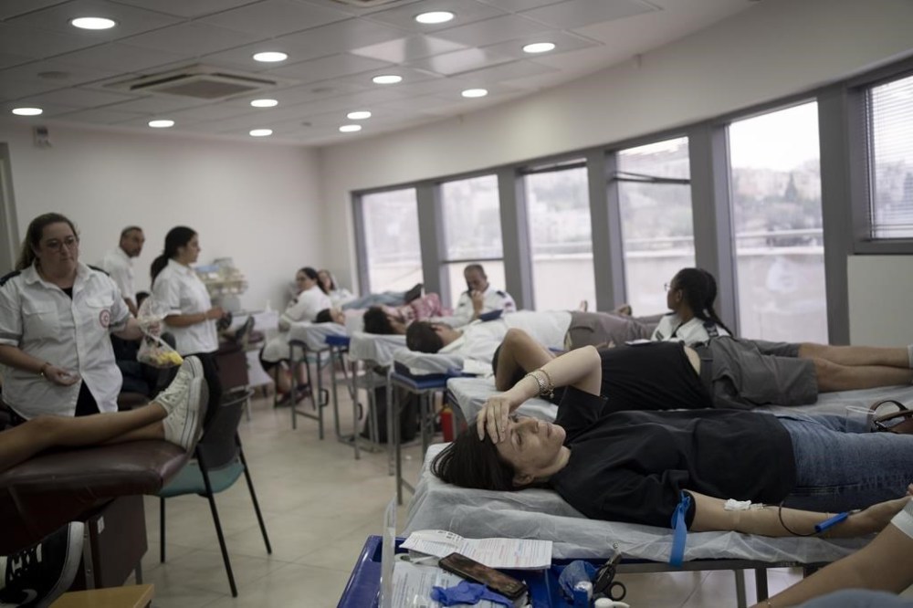 Israelis donate blood at Magen David Adom emergency service in Jerusalem, following an unprecedented attack by Hamas militants on Israel, Saturday, Oct. 7, 2023. (AP Photo/Maya Alleruzzo)