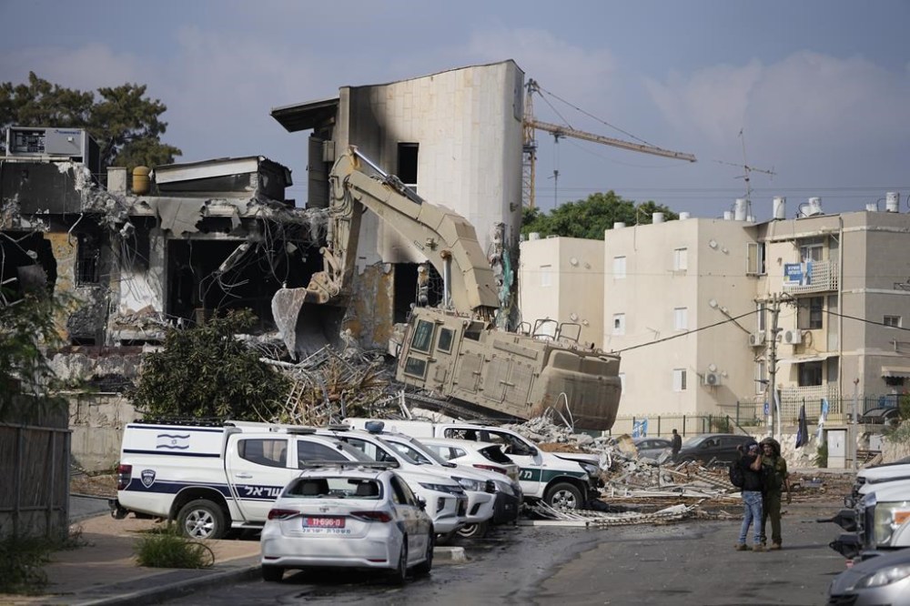 A digger removes the rubble from the police station that was overrun by Hamas militants on Saturday, in Sderot, Israel, Sunday, Oct.8, 2023. Hamas militants stormed over the border fence Saturday, killing hundreds of Israelis in surrounding communities. (AP Photo/Ohad Zwigenberg)