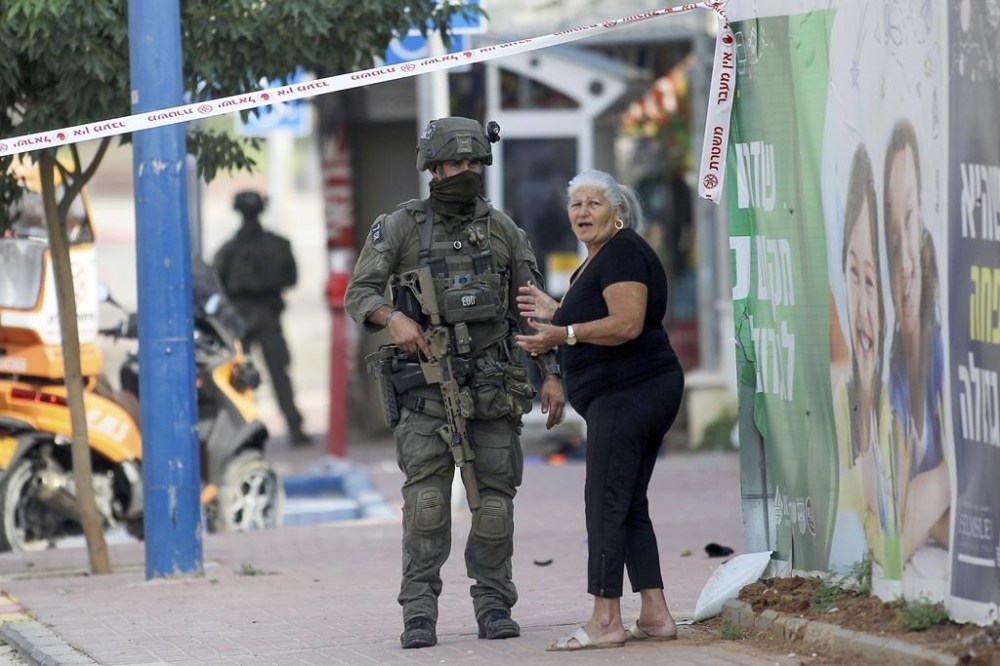 Israeli soldiers take position near a police station that was overrun by Hamas militants on Saturday, at the southern Israeli town of Sderot, Sunday, Oct.8, 2023. Hamas militants stormed over the border fence Saturday, killing hundreds of Israelis in surrounding communities. (AP Photo/Ilan Assayag)
