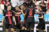 Leverkusen's Jonas Hofmann, right, is celebrated after scoring the opening goal during the German Bundesliga soccer match between Bayer Leverkusen and FC Cologne at the BayArena in Leverkusen, Germany, Sunday, Oct. 8, 2023. (AP Photo/Martin Meissner)