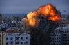 Fire and smoke rise following an Israeli airstrike, in Gaza City, Sunday, Oct. 8, 2023. Some Canadians say they are stuck in Israel in the midst of deadly fighting as airlines cancel their flights out and reaching the Canadian Embassy on a holiday weekend proves difficult. THE CANADIAN PRESS/AP/Hatem Moussa