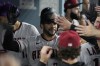 Arizona Diamondbacks' Tommy Pham celebrates with teammates after hitting a home run during the eighth inning in Game 1 of a baseball NL Division Series against the Los Angeles Dodgers, Saturday, Oct. 7, 2023, in Los Angeles. (AP Photo/Mark J. Terrill)