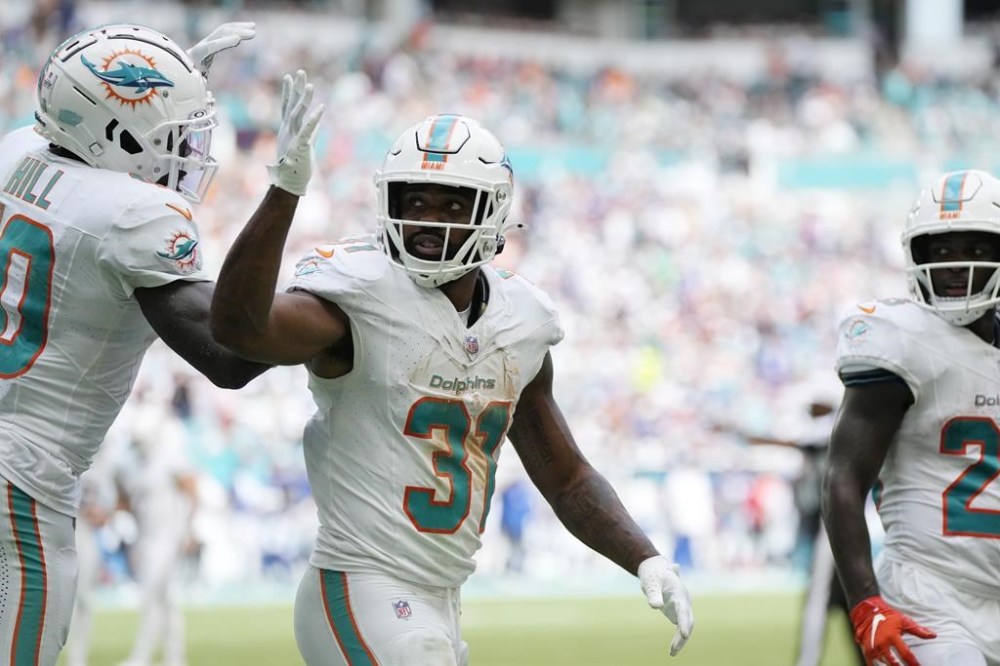 Miami Dolphins running back Raheem Mostert (31) gestures after scoring a touchdown during the second half of an NFL football game against the New York Giants, Sunday, Oct. 8, 2023, in Miami Gardens, Fla. (AP Photo/Rebecca Blackwell)