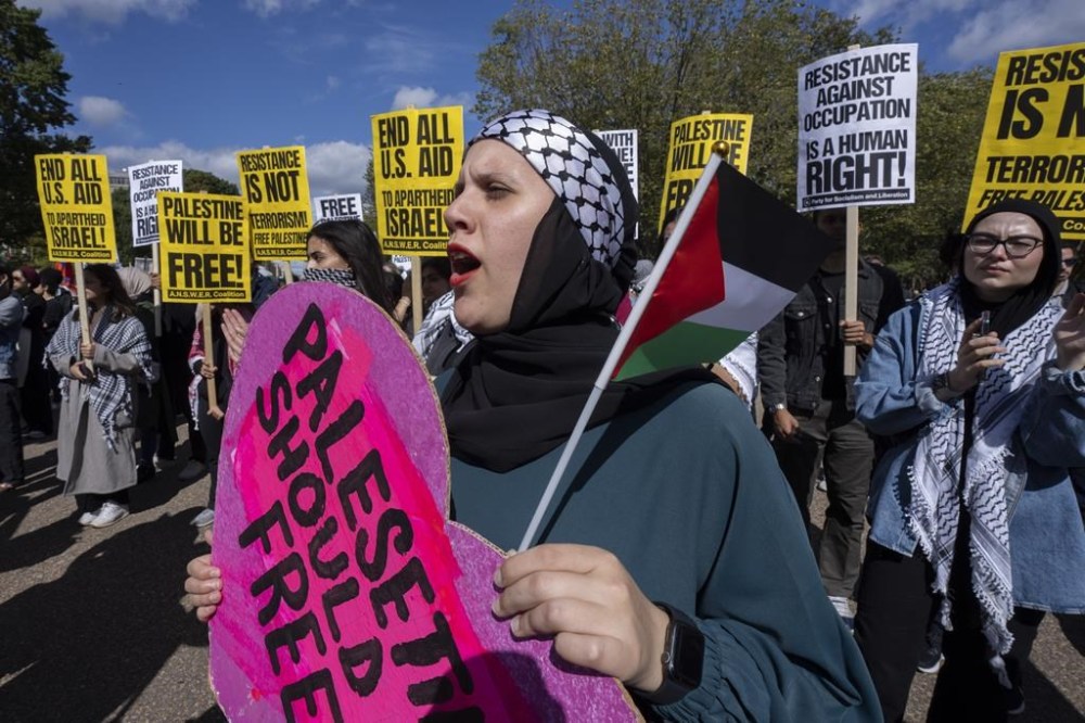 Palestinian Mai Dawod, from the West Bank city of Ramallah, joins pro-Palestinian demonstrators as they rally outside the White House in Washington, Sunday, Oct. 8, 2023. Supporters of Israel and backers of the Palestinian cause rallied in many American cities Sunday over the conflict that has killed hundreds and wounded thousands in the Middle East. (AP Photo/Manuel Balce Ceneta)