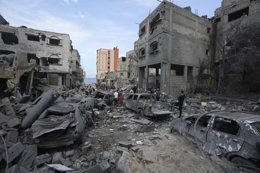 Palestinians inspect the rubble of the West mosque destroyed after it was hit by an Israeli airstrike at Shati refugee camp in Gaza City, early Monday, Oct. 9, 2023. Israel's military battled to drive Hamas fighters out of southern towns and seal its borders Monday, as it pounded the Gaza Strip from the (AP Photo/Adel Hana)