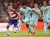 Granada's Lucas Boye fights for the ball with Barcelona's Lamine Yamal during a Spanish La Liga soccer match between Granada and Barcelona at Los Carmanes Stadium in Granada, Spain, Sunday, Oct. 8, 2023. (AP Photo/Fermin Rodriguez)