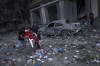 Palestinians walk amid the rubble following Israeli airstrikes that razed swaths of a neighborhood in Gaza City, Tuesday, Oct. 10, 2023. The militant Hamas rulers of the Gaza Strip carried out an unprecedented attack on Israel Saturday, killing over 900 people and taking captives. Israel launched heavy retaliatory airstrikes on the enclave, killing hundreds of Palestinians. (AP Photo/Fatima Shbair)