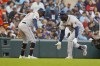 Houston Astros' Yordan Alvarez, right, greets third base coach Gary Pettis (8) after hitting a solo home run in the ninth inning during Game 3 of an American League Division Series baseball game against the Minnesota Twins, Tuesday, Oct. 10, 2023, in Minneapolis. (AP Photo/Bruce Kluckhorn)