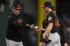 Baltimore Orioles starting pitcher Dean Kremer, right, is taken out of the game by manager Brandon Hyde, left, in the second inning of Game 3 of a baseball AL Division Series against the Texas Rangers on Tuesday, Oct. 10, 2023, in Arlington, Texas. (AP Photo/Tony Gutierrez )
