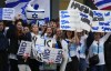 Young demonstrators wave signs on a street corner during a rally in support of Israel, Monday, Oct. 9, 2023, in Bellevue, Wash., in the wake of an attack on Israel by Hamas militants. (AP Photo/Lindsey Wasson)