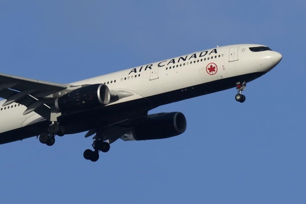 An Air Canada Airbus A330 approaches for landing in Lisbon, Saturday, Sept. 2, 2023. Air Canada says it has grounded a pilot who made what it called unacceptable posts about Israel after Hamas carried out deadly attacks on that country over the weekend. THE CANADIAN PRESS/AP-Armando Franca
