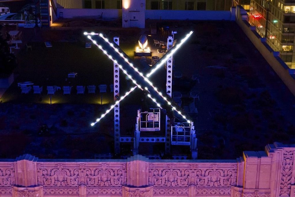 File - Workers install lighting on an
