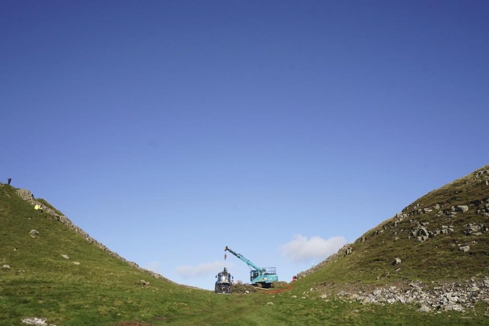 A view of the removal of the felled Sycamore Gap tree, on Hadrian's Wall in Northumberland, England, Thursday, Oct. 12, 2023. One of the UK’s most photographed trees was “deliberately felled” last month in an apparent act of vandalism, authorities have said. The famous tree at Sycamore Gap, next to Hadrian’s Wall in Northumberland, was made famous when it appeared in Kevin Costner’s 1991 film Robin Hood: Prince Of Thieves. (Owen Humphreys/PA via AP)